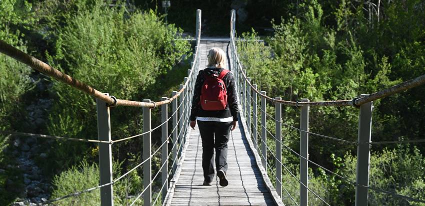 lady on the bridge of Juliana Trail hiking slovenia