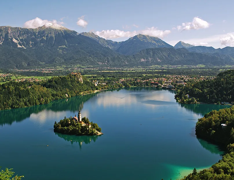 Aerial view of Lake Bled with island church and the Julian Alps, Slovenia