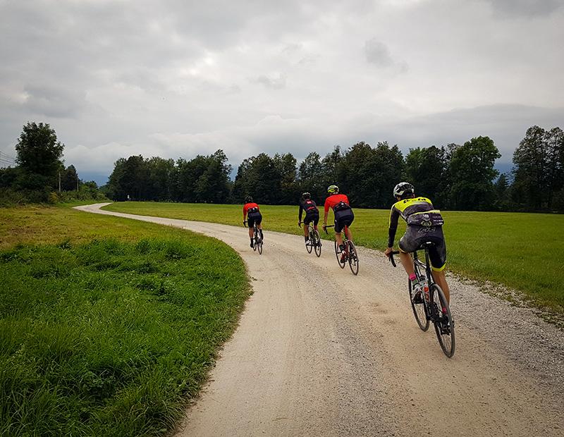 Group of cyclists riding gravel roads in Slovenia’s countryside during a self-guided cycling holiday.