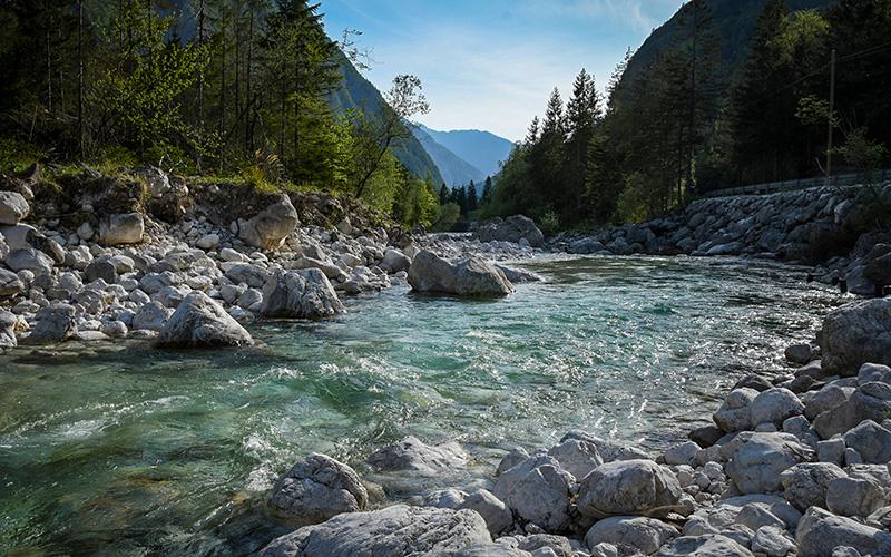 Turquoise alpine river flowing through the Soča Valley in Slovenia, popular stop on self-guided hiking and trekking holidays.